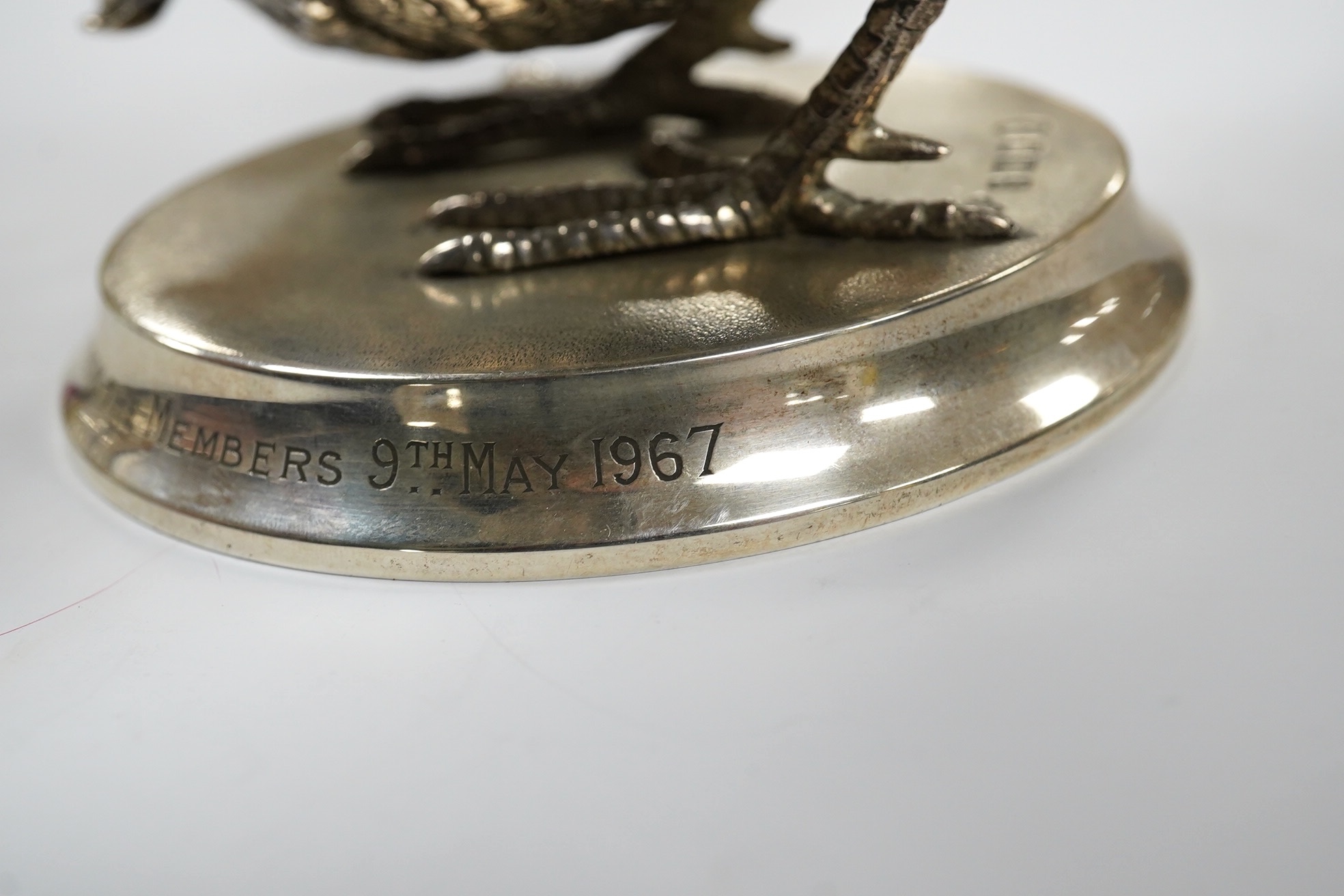 An Elizabeth II silver presentation cockerel, on a circular base with engraved inscription, by Garrard & Co Ltd, London, 1953, overall height 14cm, weighted. Condition - fair to good